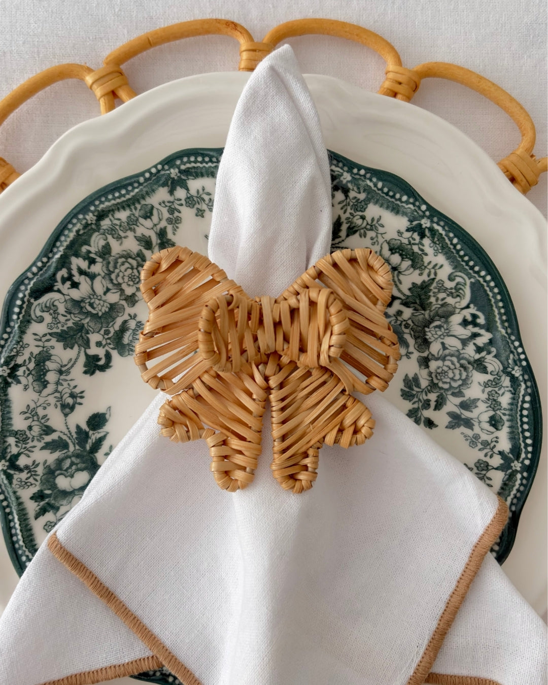 Statement Double Bow Rattan Napkin Ring adding natural texture to an elegant table setting