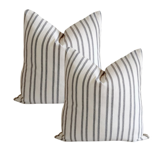 Set of two taupe woven jacquard cushion covers with raised decorative texture.