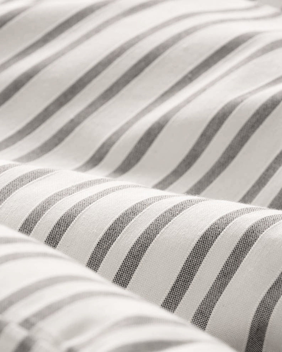 Close-up of the taupe jacquard weave showing the real cotton soft feel.